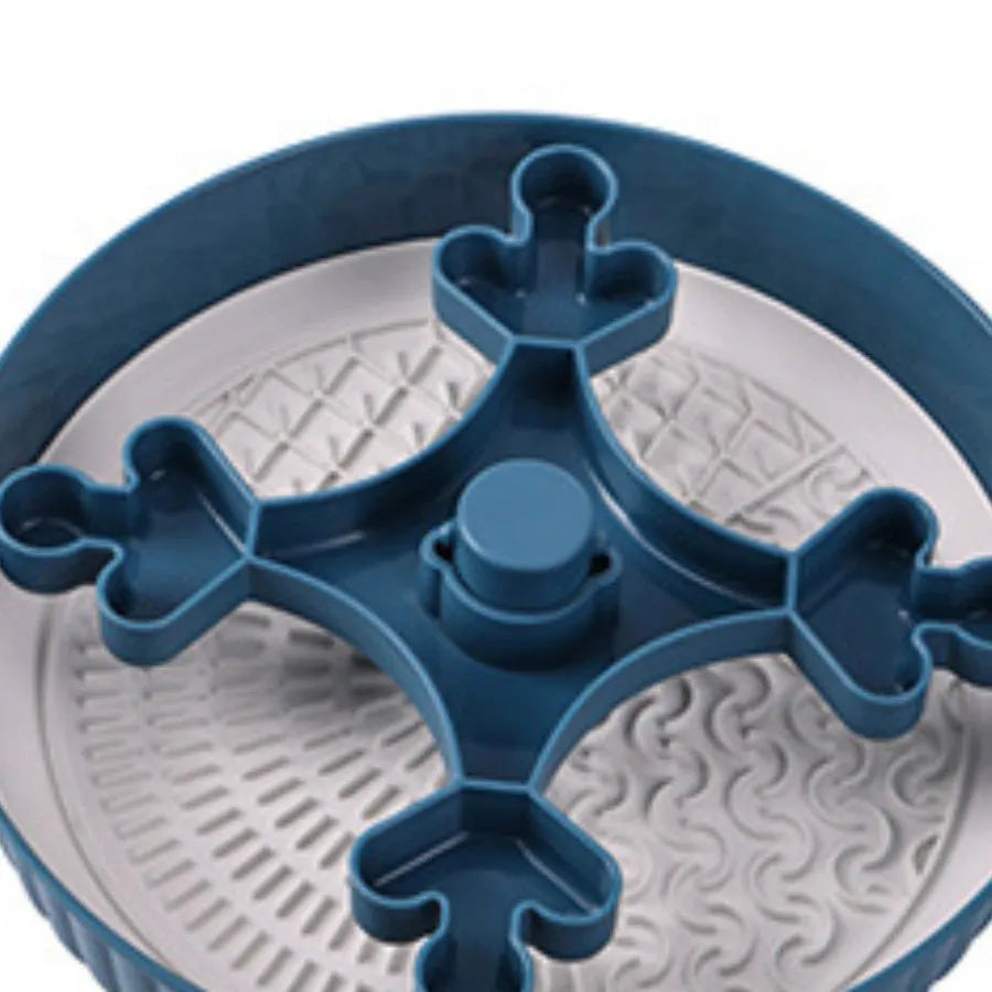 Grey rotating pet slow feeder bowl with a blue silicone windmill-pattern licking mat attached.