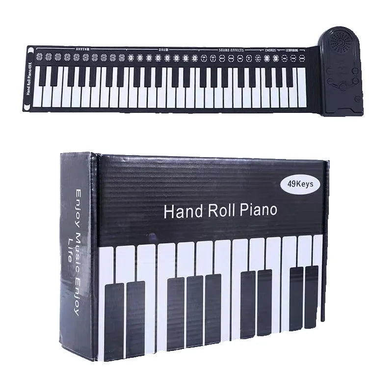 Rolled-up silicone keyboard next to black ABS control unit and speaker for portable 49-key electronic piano.
