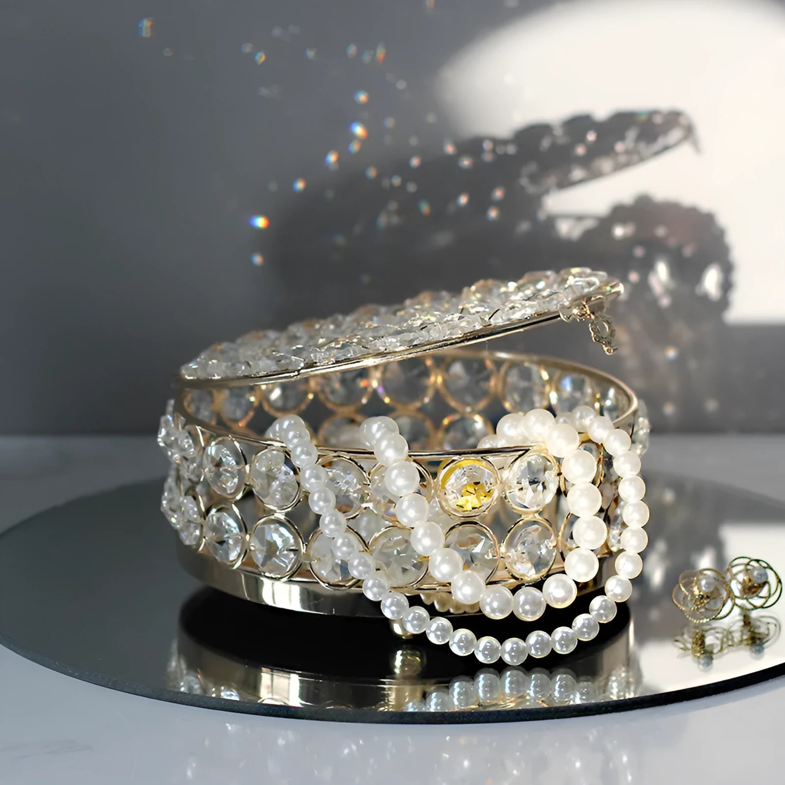 French gold metal frame jewellery box with transparent crystal glass panels displaying contents