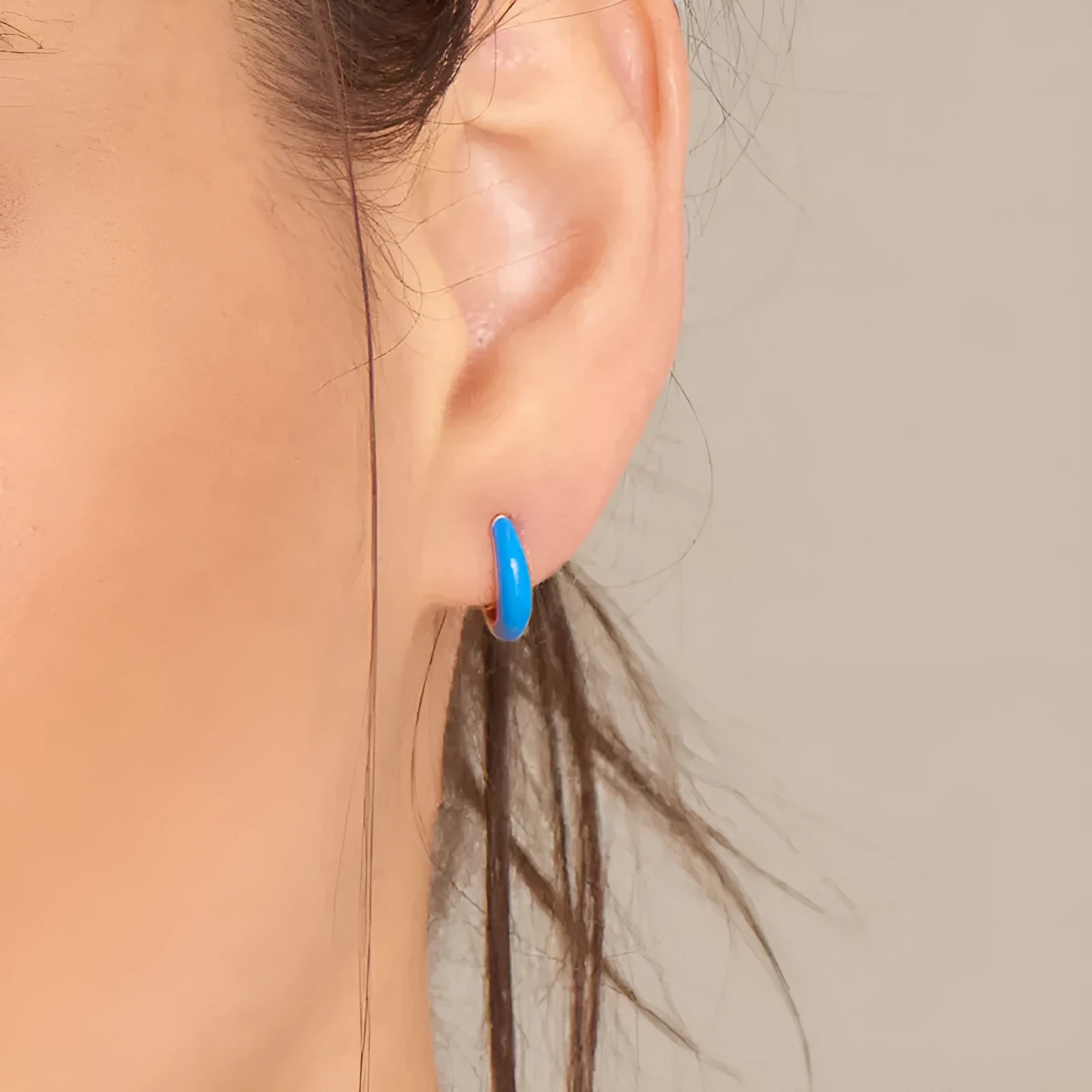 Geometric epoxy resin earrings with dripping oil colour technique showing oval curves and integrated rings