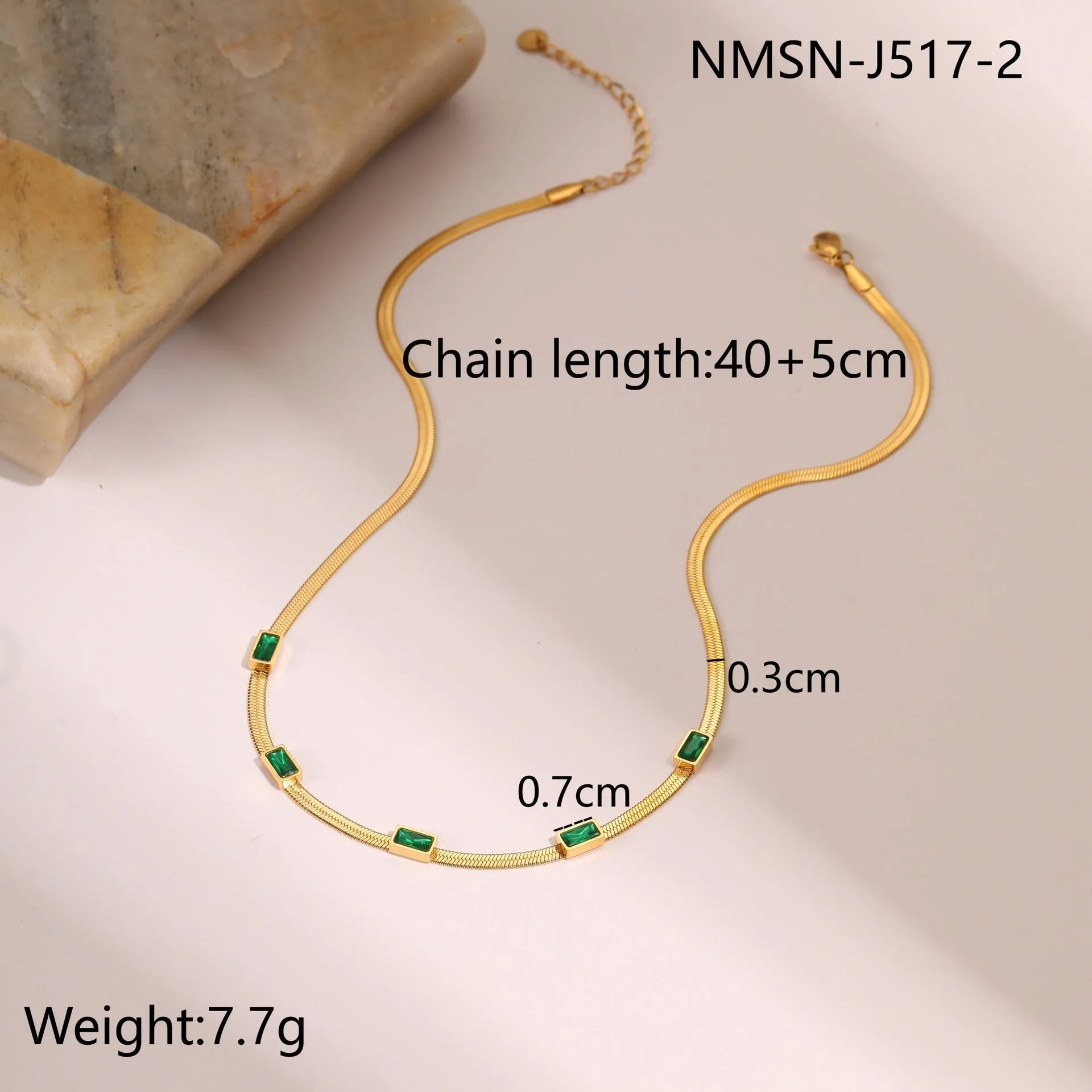 Gold geometric square zircon pendant necklace on a flat stainless steel snake chain.