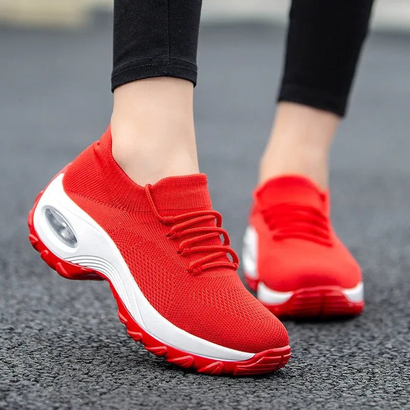 Women's flying knit platform sneakers in black with round toe and waterproof sole