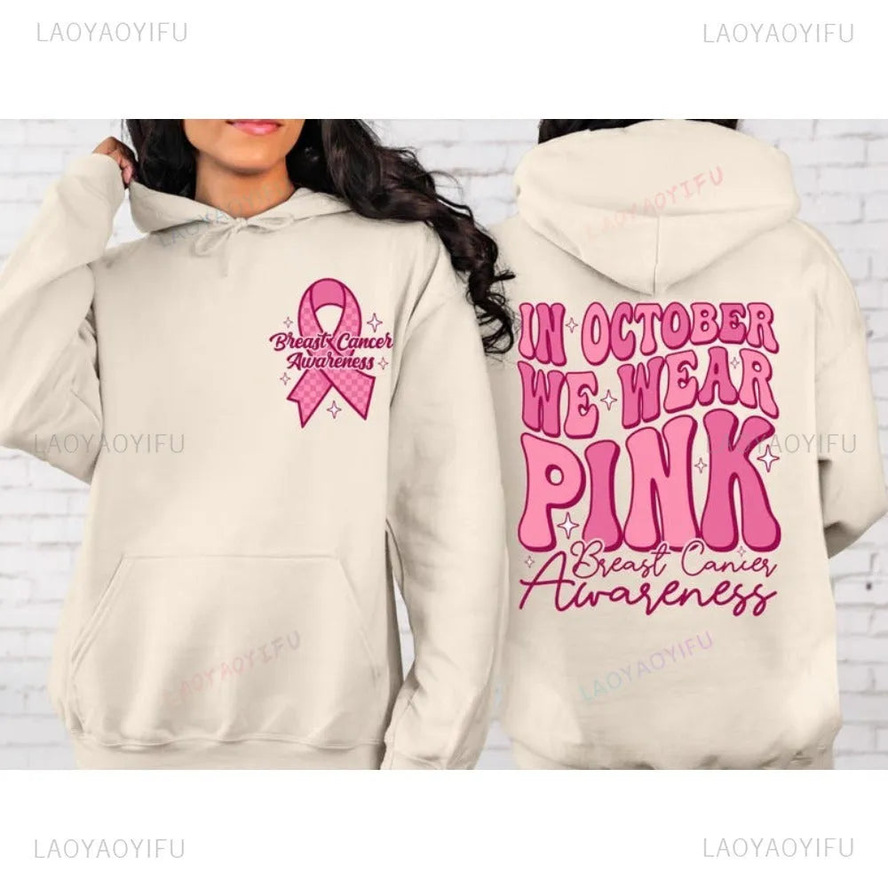 Women's pink breast cancer awareness pullover hoodie with retro graphic design and side seam pockets.