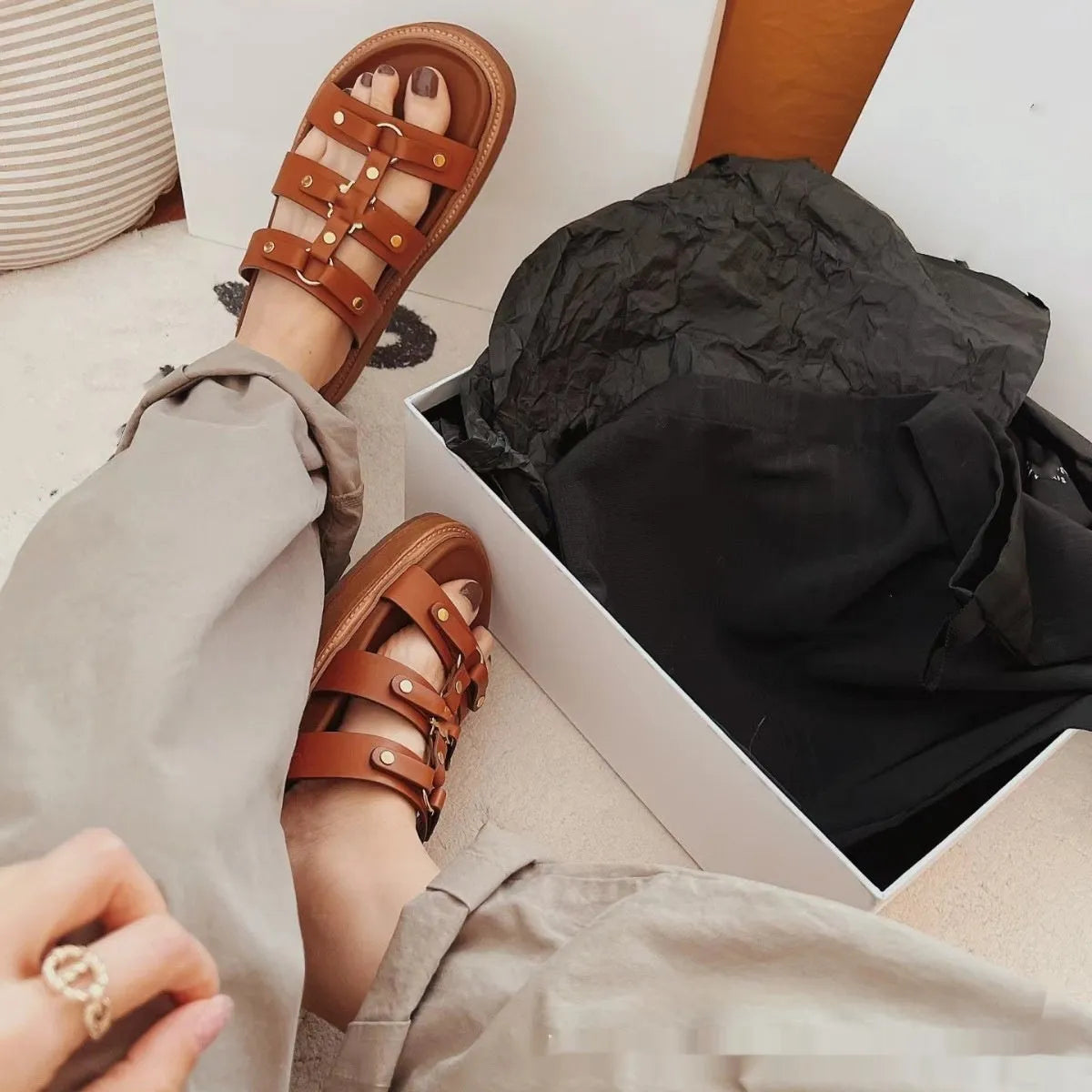 Women's white patent leather Roman sandal slippers with sheepskin upper and ankle strap.