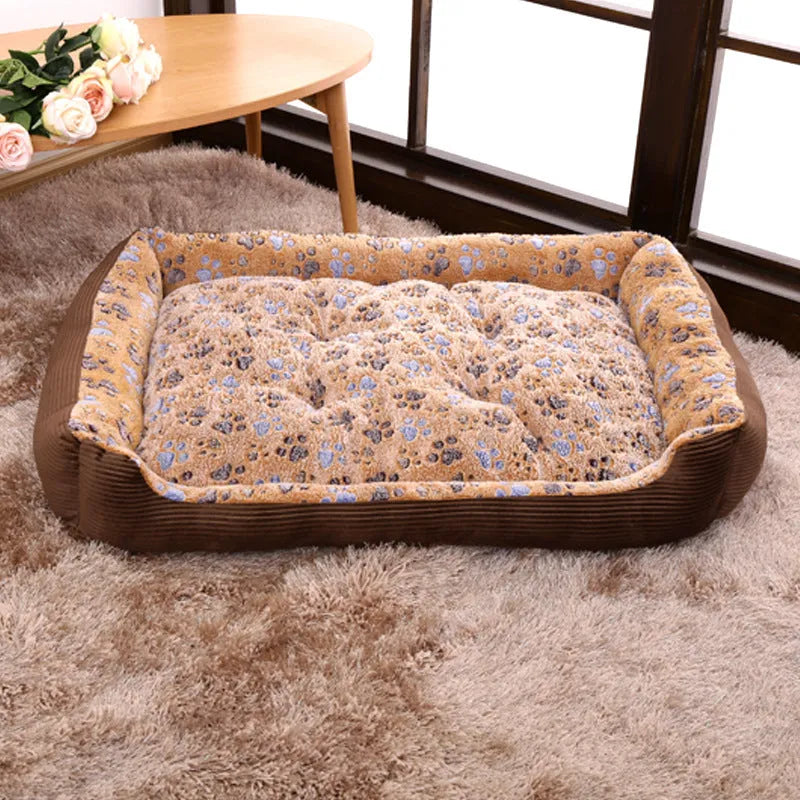 Beige plush sofa-style pet bed for a small dog, showing bolstered sides and padded construction.
