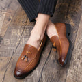 Men's black pointed toe slip-on business shoes with tassel detail on artificial PU leather upper