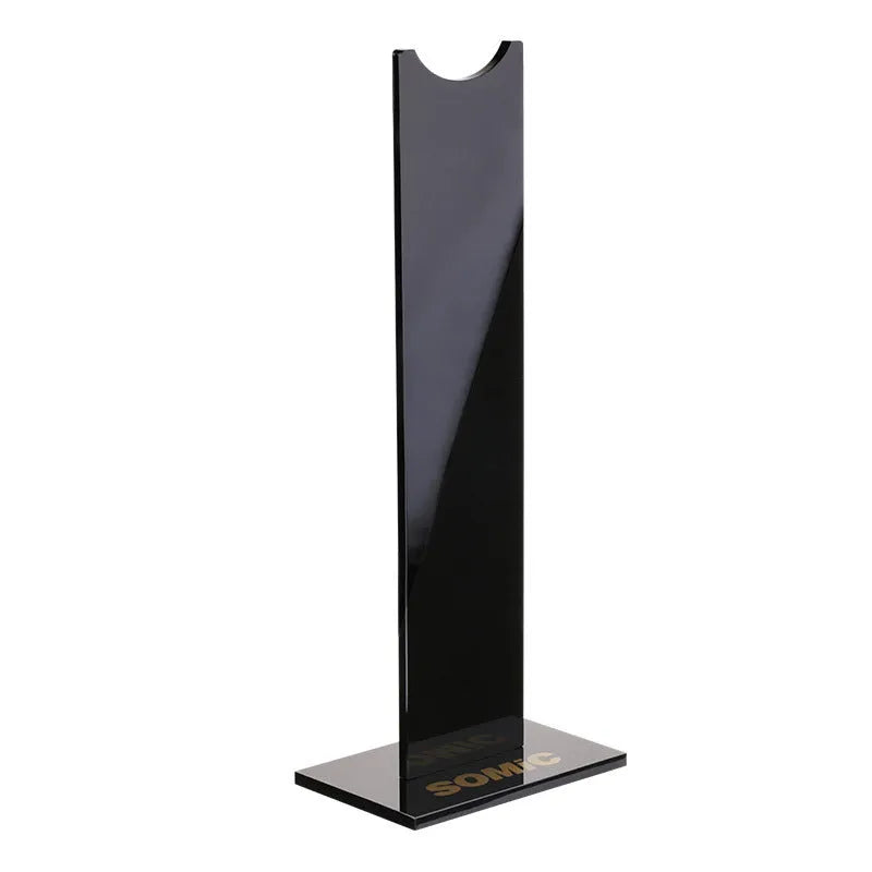 Pink and black detachable gaming headset stand with non-slip silicone base on a desk