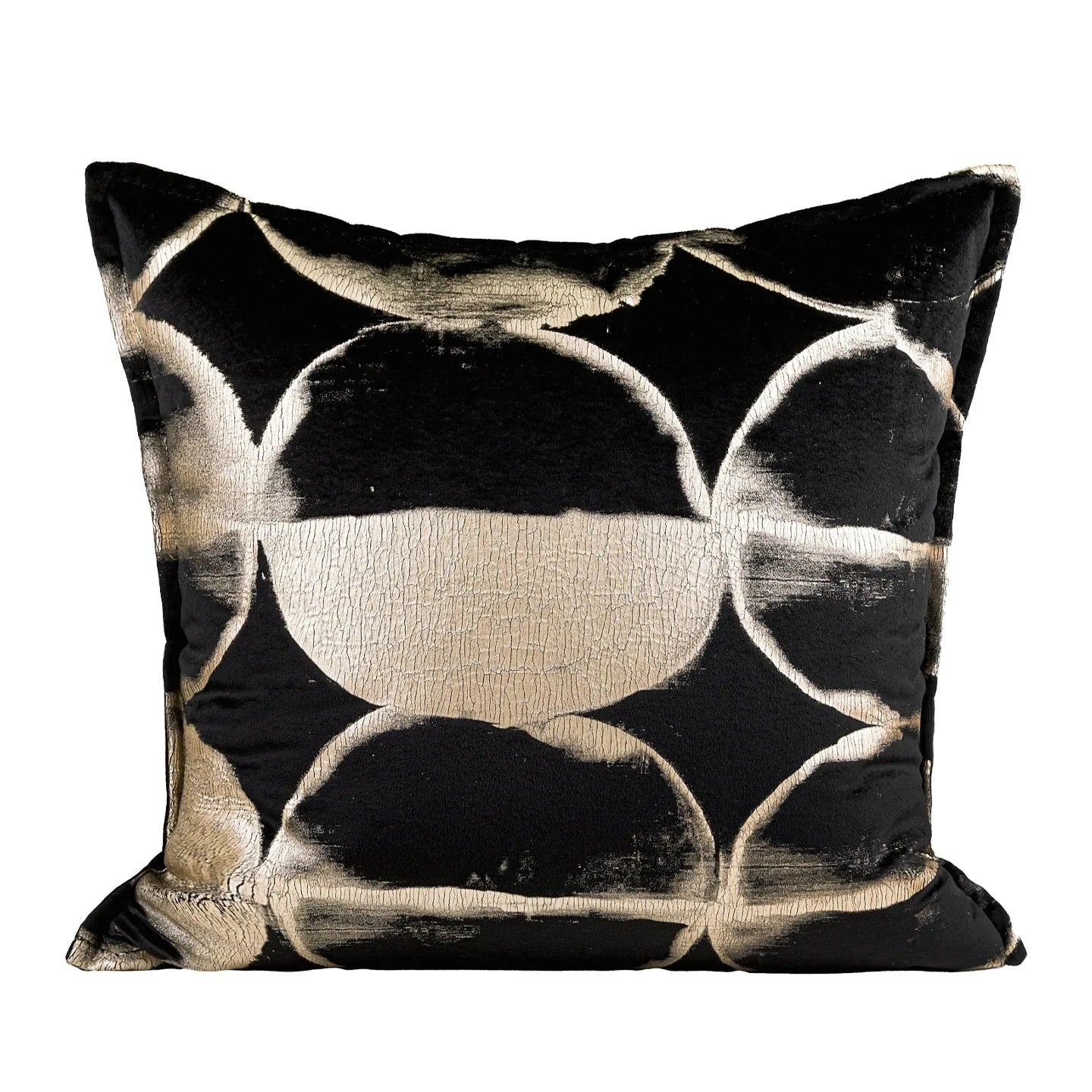 Black and gold abstract pattern decorative cushion with removable cover on a grey sofa.