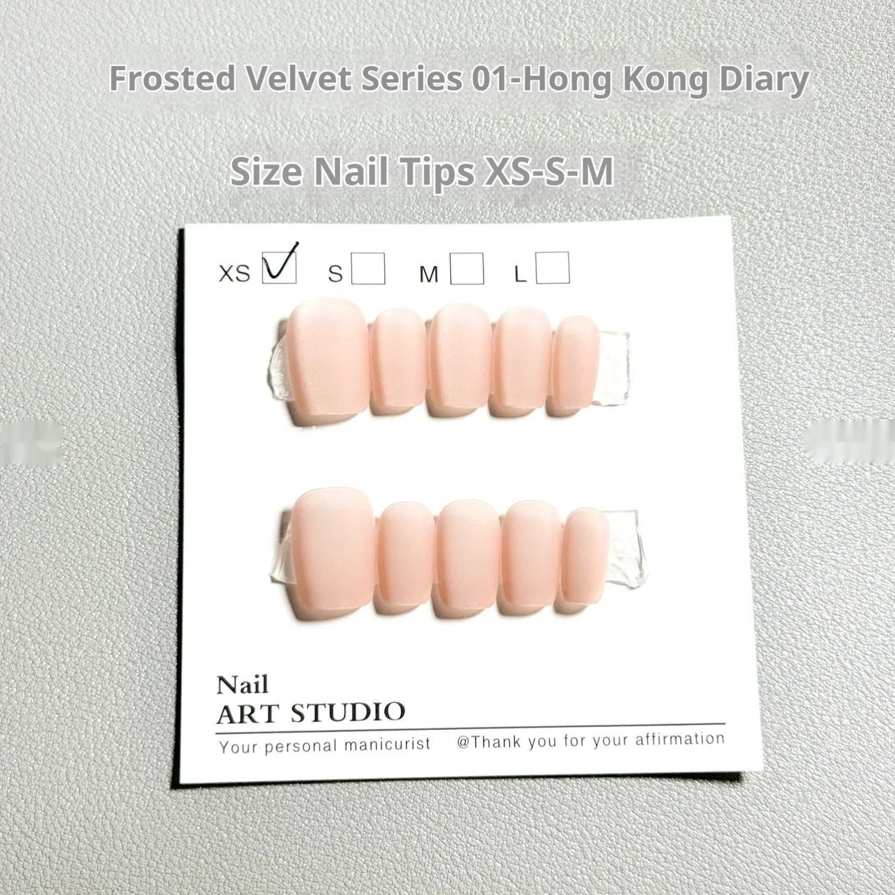 Set of frosted velvet false nails with Cat's Eye effect in short ladder sizes XS, S, and M on a clear background.