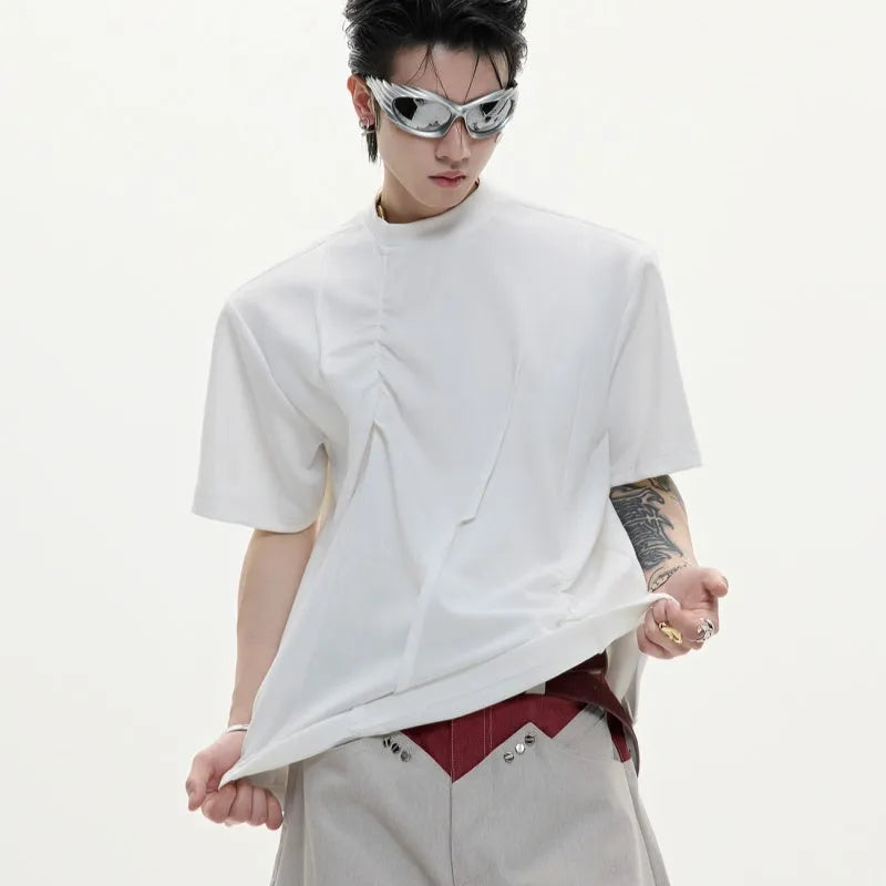 Men's grey cotton T-shirt with pleated detail on the front, showing a loose fit and round neck.