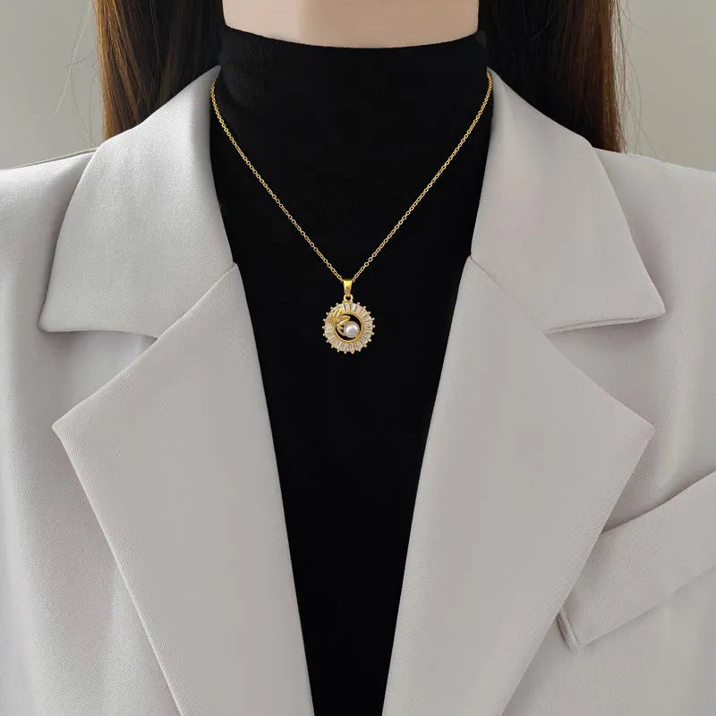 Square geometric necklace with diamond and leaf design alongside matching stud earrings