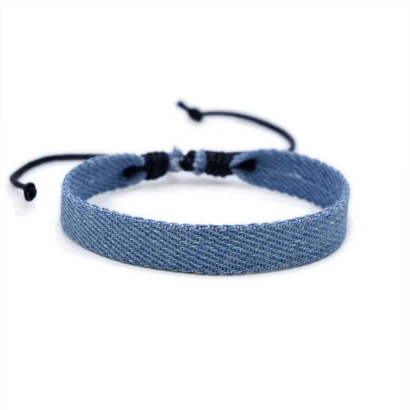 Handmade denim fabric wristband carrying strap in mixed materials with adjustable closure