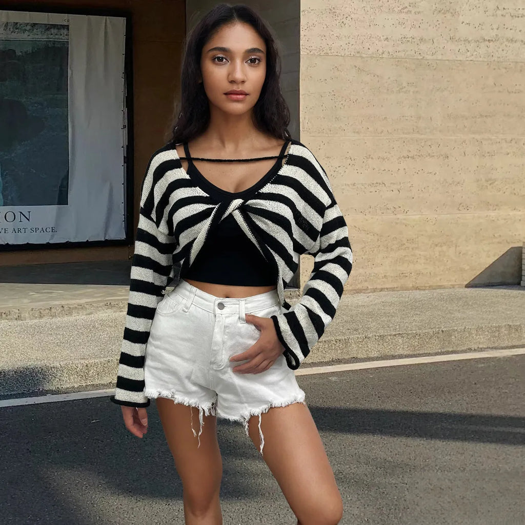 Striped long-sleeved cotton sweater with an exposed navel design on a model