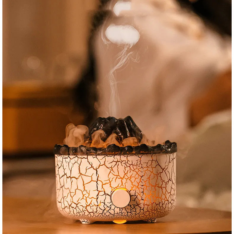 Volcano humidifier with LED lights and mist creating a fiery flame effect, column-shaped plastic body on a table