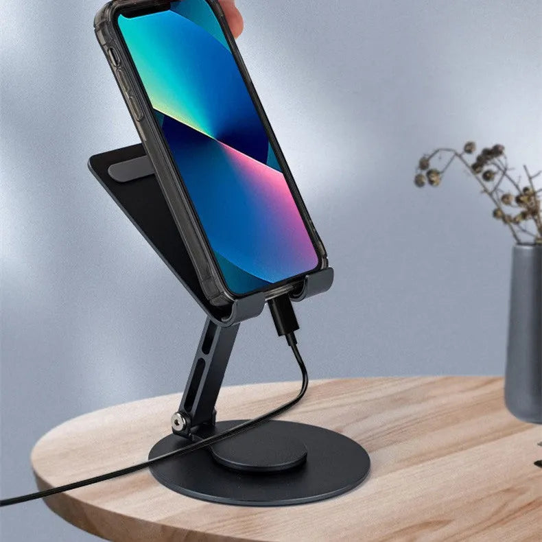 Aluminum alloy rotating mobile phone bracket in grey with silicone grip on desk showing phone in portrait mode