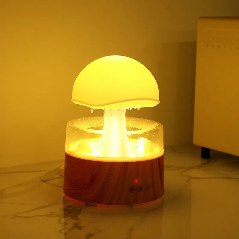 White cloud rain humidifier with rainfall simulation and LED lighting on wooden surface