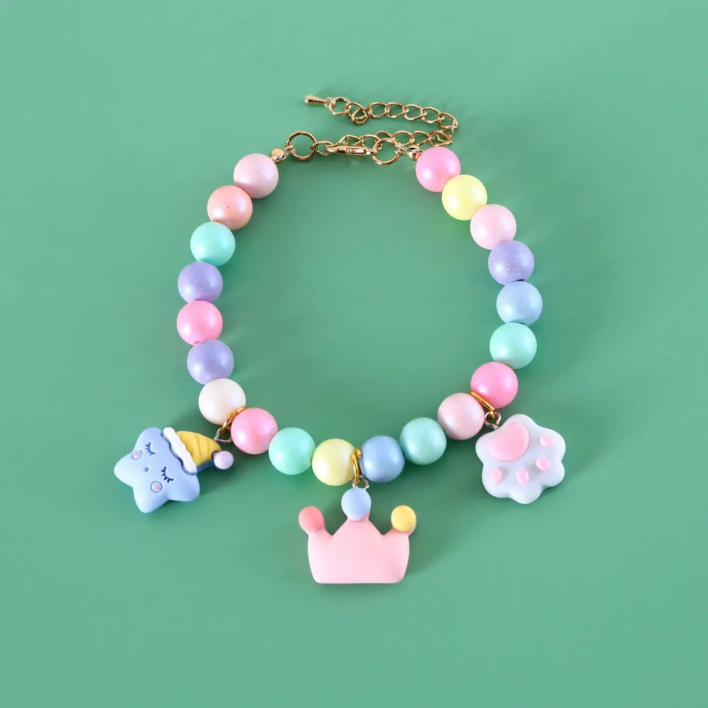 Colourful resin pet jewellery with moon and meteor motifs in macaron colours for dogs and cats