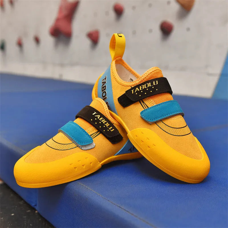 Beginner rock climbing shoes with Velcro strap in black and red colour.