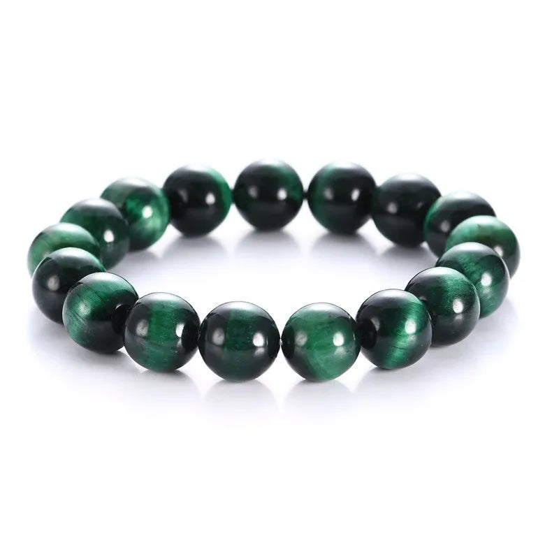 Green tiger eye stone geometric bead bracelet with adjustable closure on a wrist.
