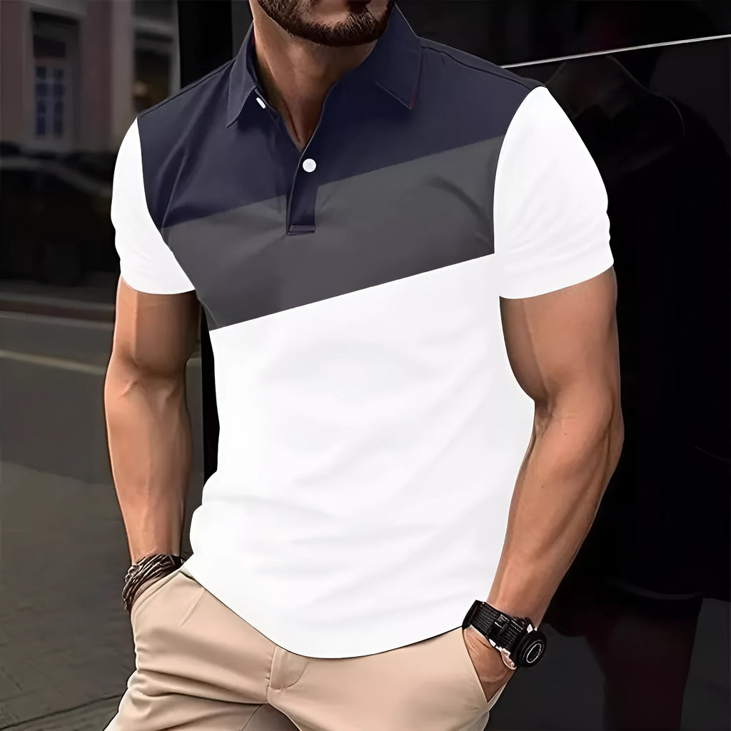 Man wearing a loose-fit grey T-shirt with a colourful abstract 3D digital print on the front.