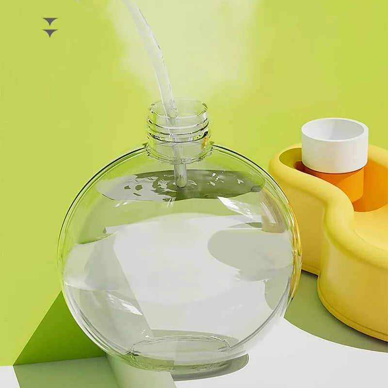 Green portable pet travel cup with extended drinking bowl and water bottle handle.