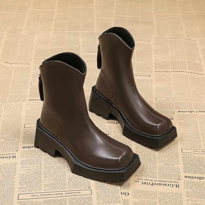 Black platform Martin boots for women with square toe, high heel, and back zip on a white background.