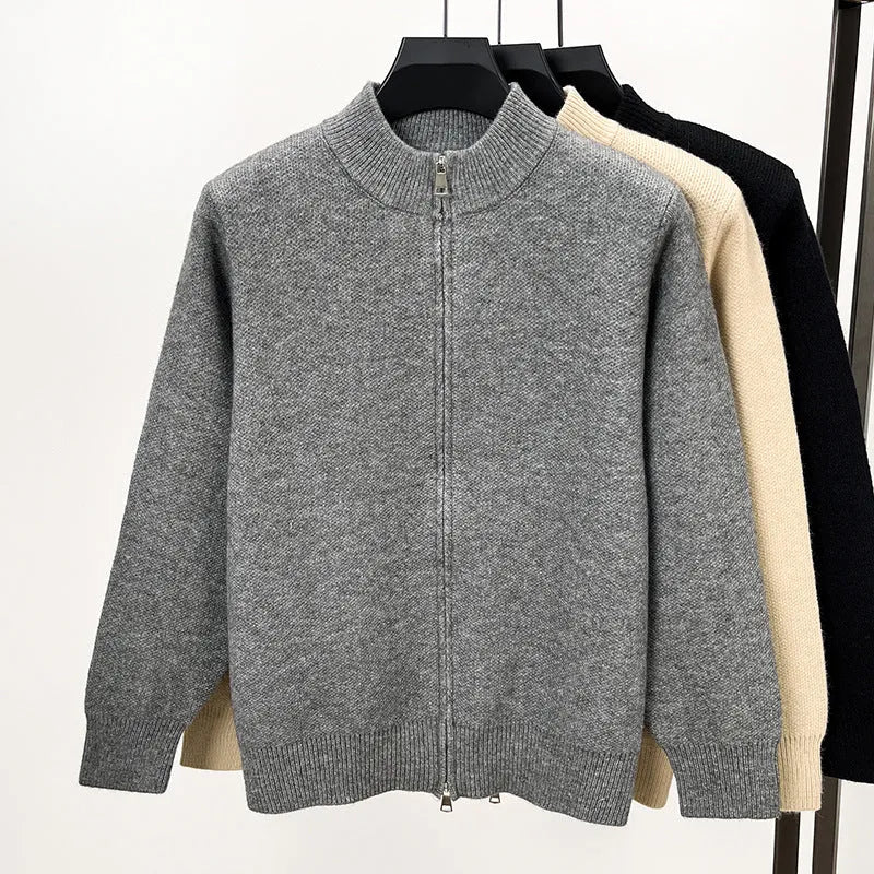 Man wearing a beige high collar zip-front knit cardigan, loose fit, long sleeves.