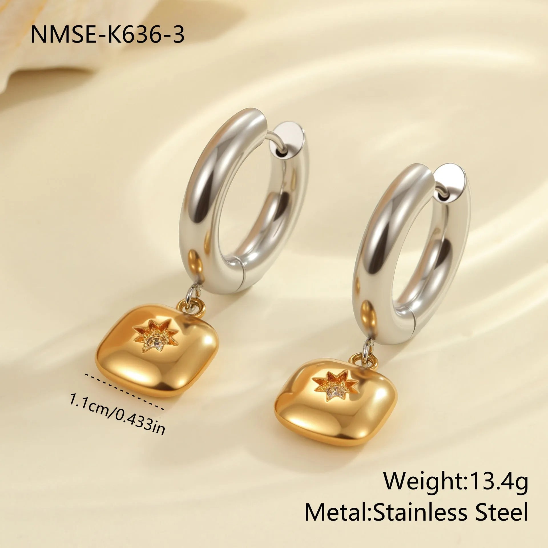 A pair of stainless steel earrings with an 18K gold colour finish, shown in a Christmas tree shape and a heart shape.