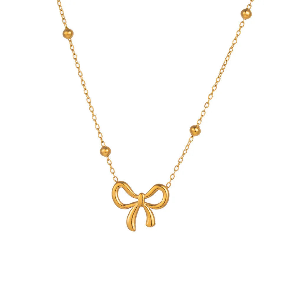 Gold bow necklace with cross chain design showing adjustable length from 41 to 50cm
