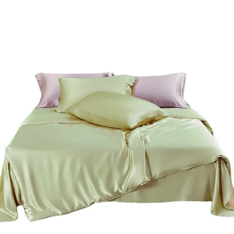 Reversible silk duvet cover folded to show Lotus Pink and pea green sides, with bright brown and silver blue colour swatches.