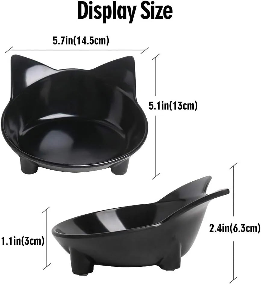 Set of four shallow black and white cat bowls with non-slip bases on a kitchen counter