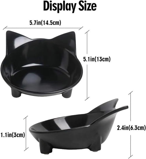 Set of four shallow black and white cat bowls with non-slip bases on a kitchen counter