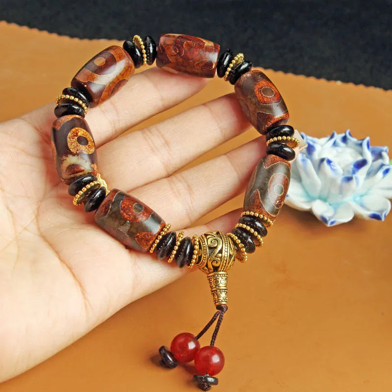 Agate Tibetan dzi bead bracelet with three-eye design and polished finish