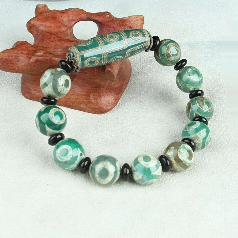 Agate Tibetan dzi bead bracelet with three-eye design and polished finish
