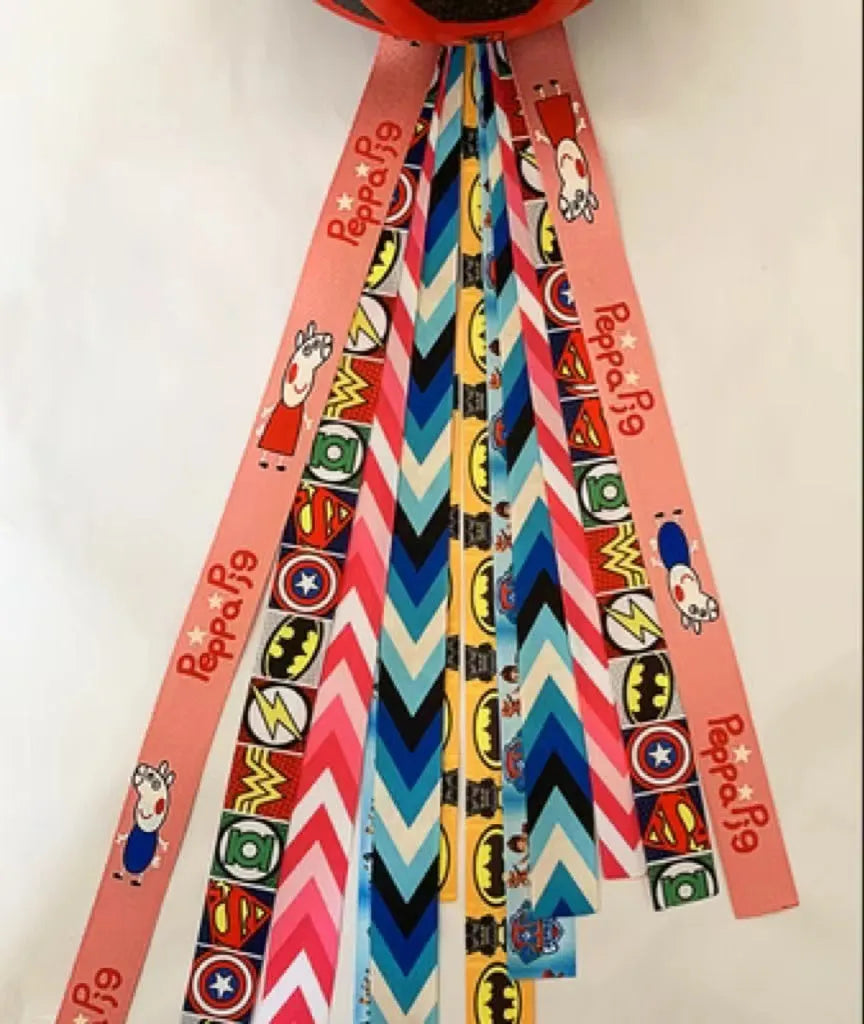 Close-up of a colourful decorative ribbon streamer attached to a child's helmet for roller skating or skiing.