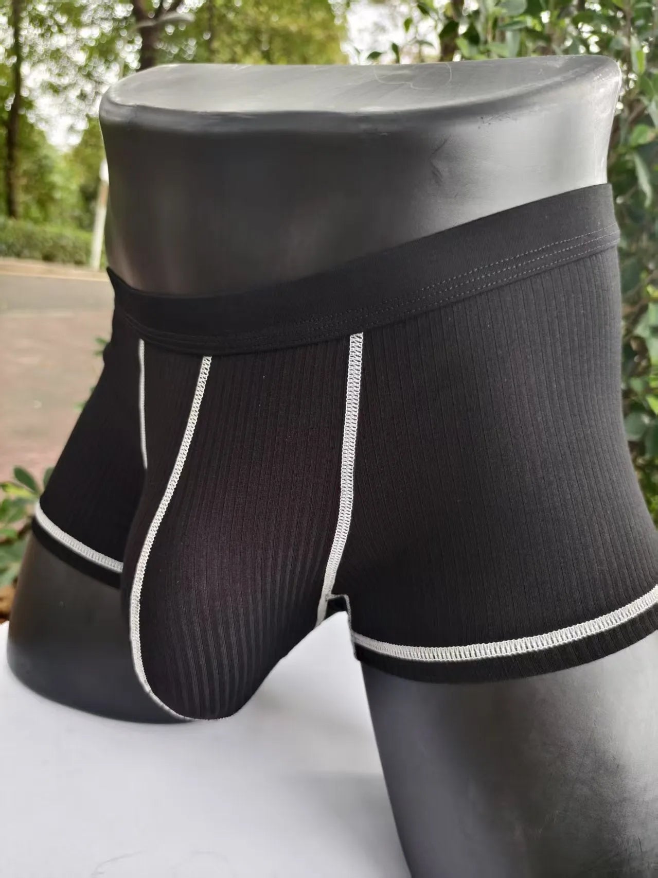 Men's thin fibre boxer shorts in army green, shown laid flat to display hip lift design.
