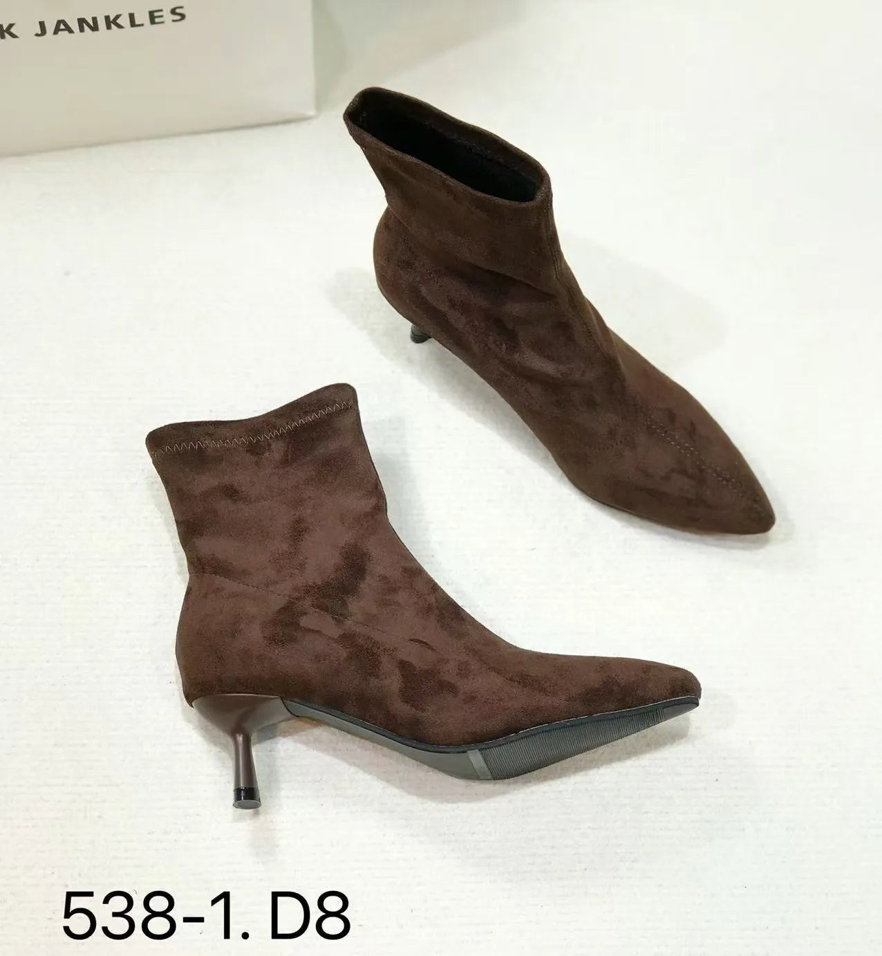 Women's black pointed toe ankle boots with a stiletto heel and mid-calf sock length.