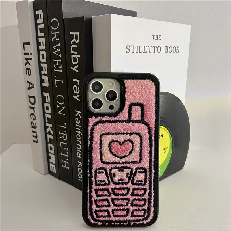 Soft pink TPU iPhone case with a towel-like embroidered texture on the back.