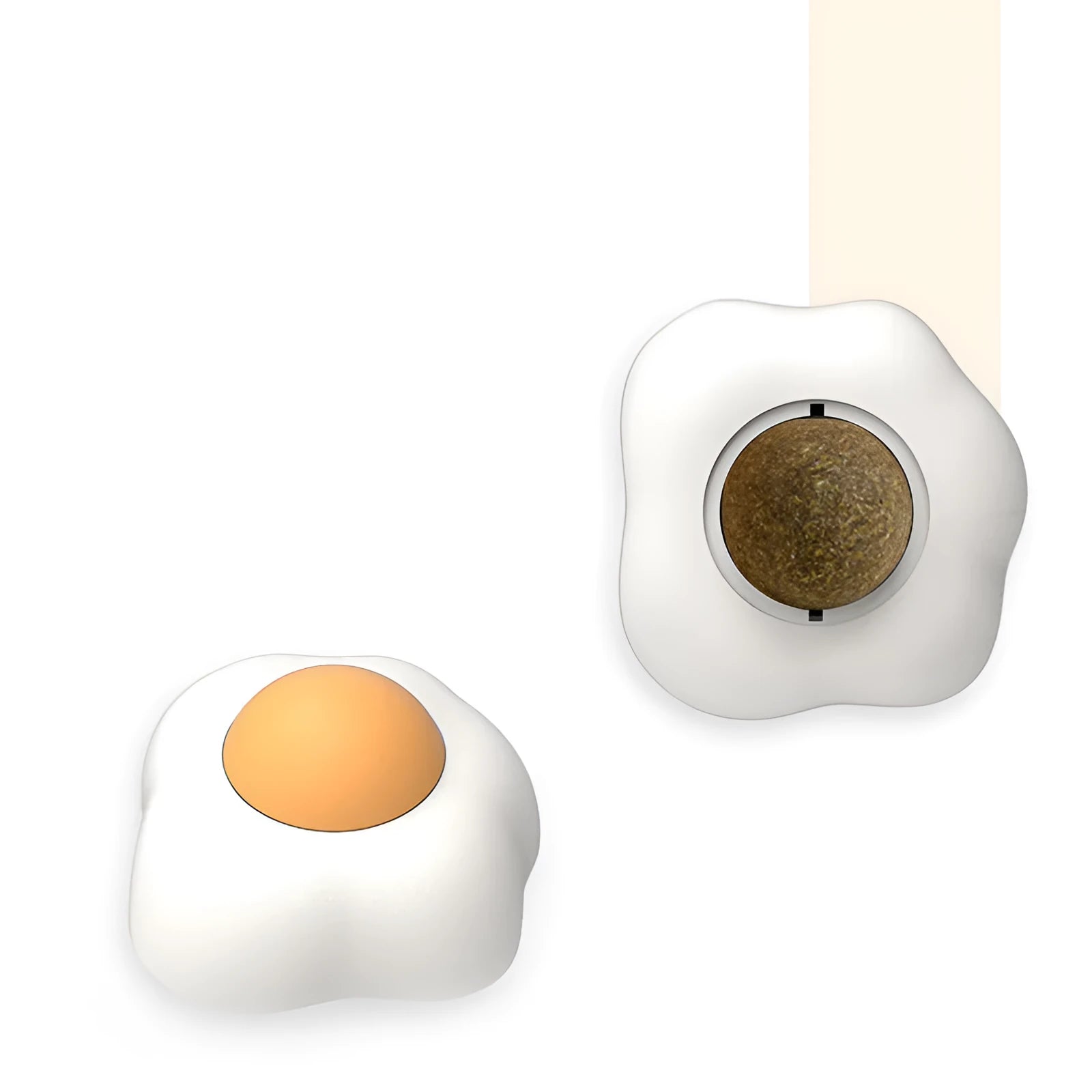 Soft plush catnip ball toy in fried egg shape stuck to a wall, with a cat playing.