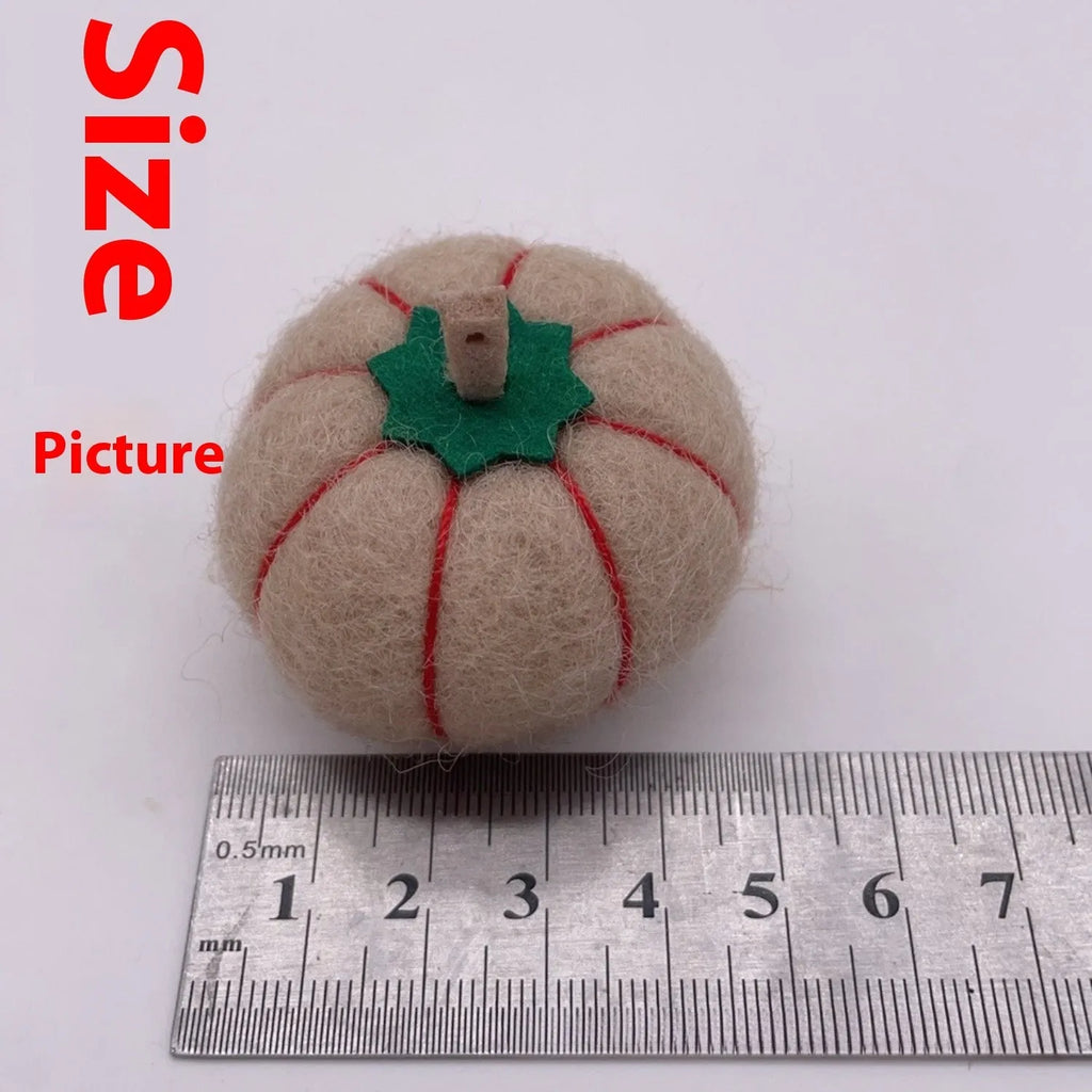 Wool felt pumpkin ornament in assorted colours for dollhouse decoration, approx. 5cm wide.