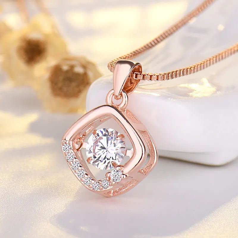 Silver love heart-shaped necklace with crown and bow decoration on clavicle