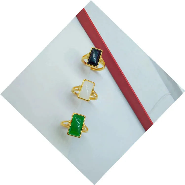 Adjustable brass ring with gold plating and coloured gemstone in national style design