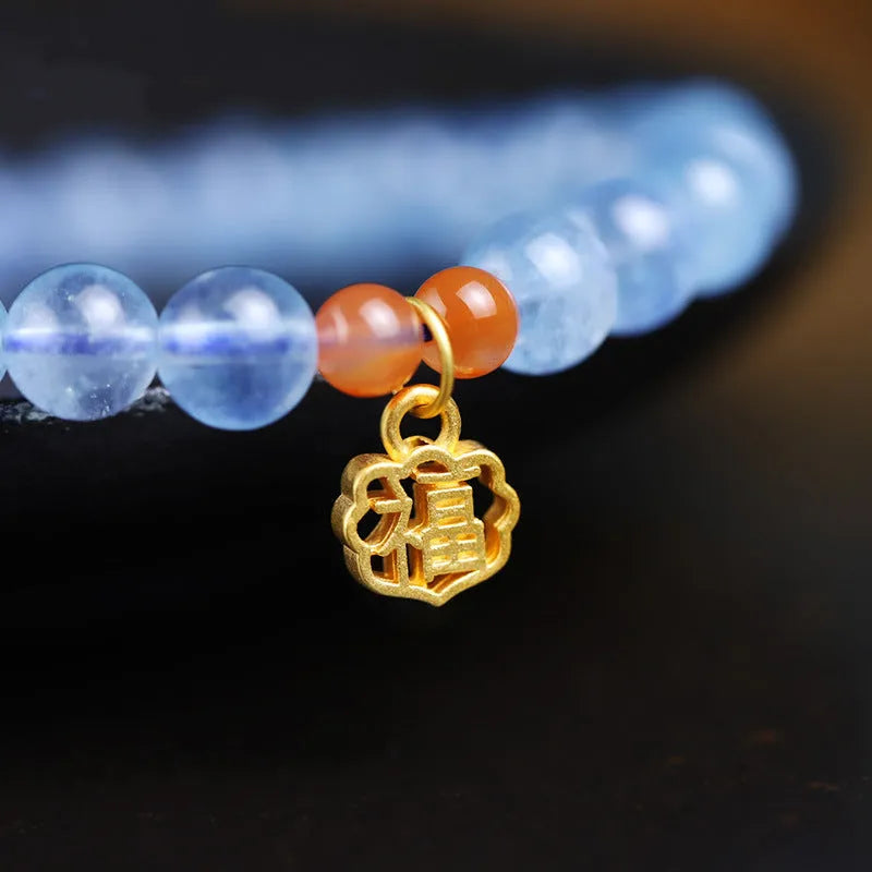 Aquamarine natural crystal bead bracelet with sequin charms on elastic cord