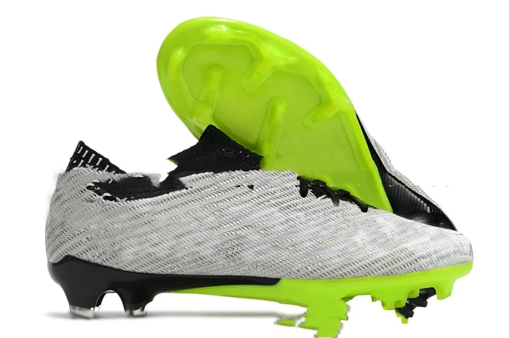 Men's low top waterproof knitted football shoes with FG rubber studs on white background