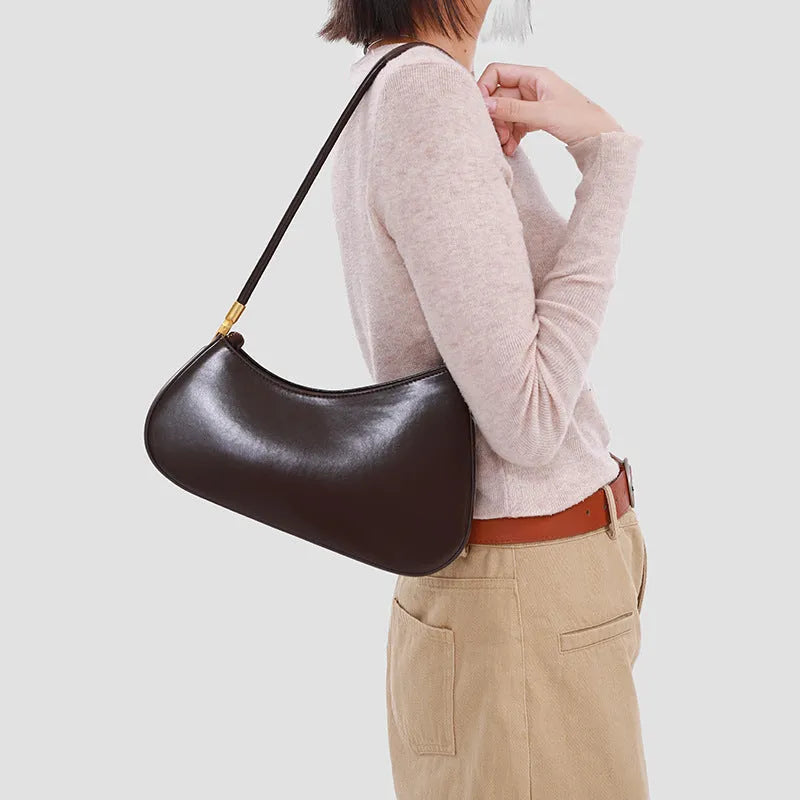 Retro oval women's underarm handbag in multiple colours, showing sandwich pocket design and single shoulder strap.