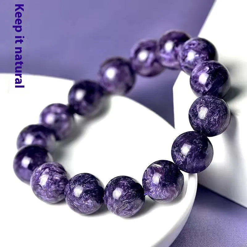Natural purple charoite crystal bracelet with platinum details, showing different bead size options.