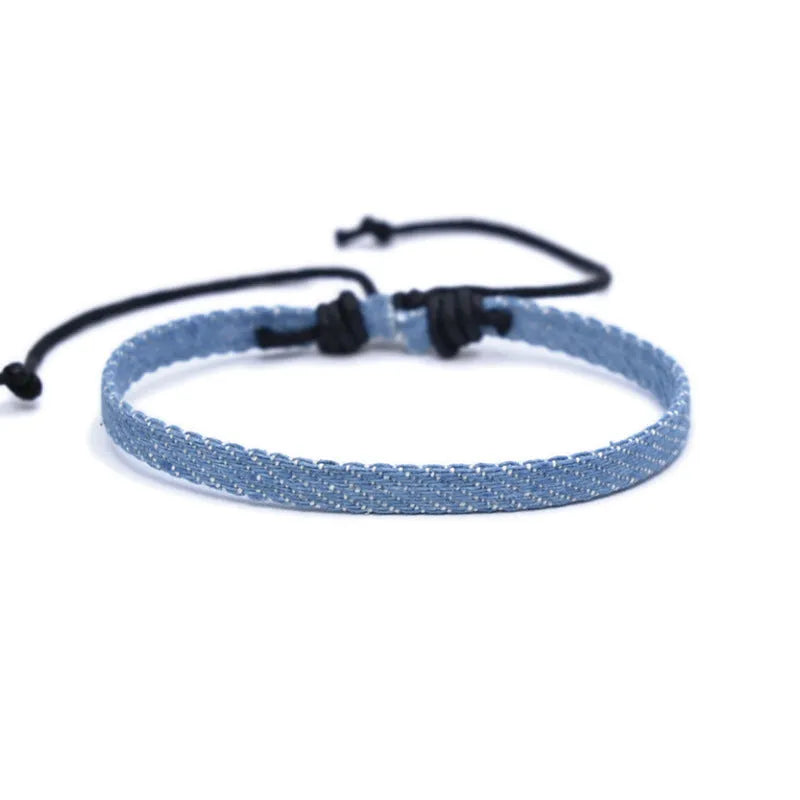 Handmade denim fabric wristband carrying strap in mixed materials with adjustable closure