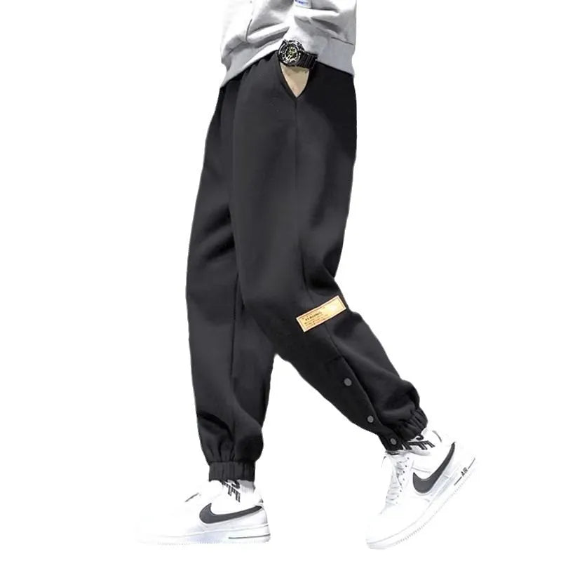 Velvet padded casual trousers for women in regular black with ankle strap and skinny leg style