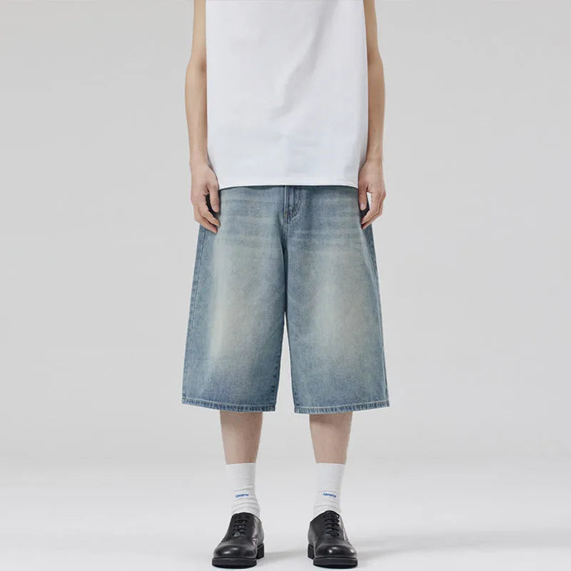 Men's light blue loose-fit cropped denim shorts with a straight leg on a neutral background.