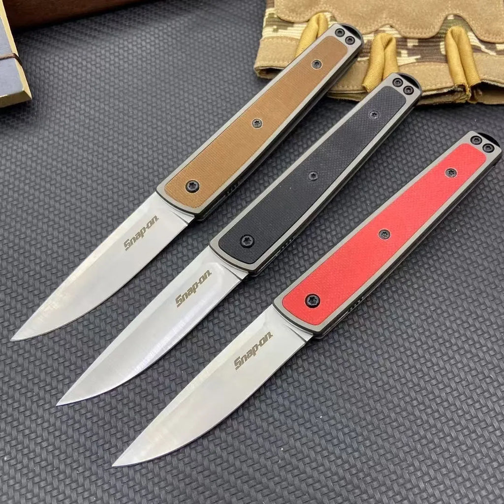 Folding fruit knife with stainless steel blade shown in black, brown, and red colour options